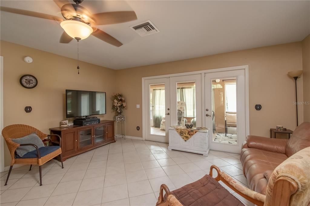 E. FORMAL LIVING ROOM WITH DOORS TO FLORIDA ROOM