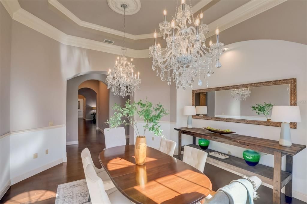 Loads of bright light in this formal dining room with gorgeous chandelier