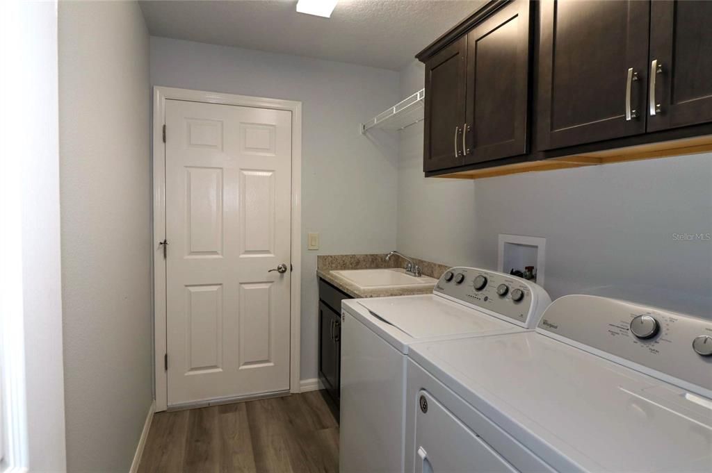 Laundry room is interior and has a sink and great storage cabinets