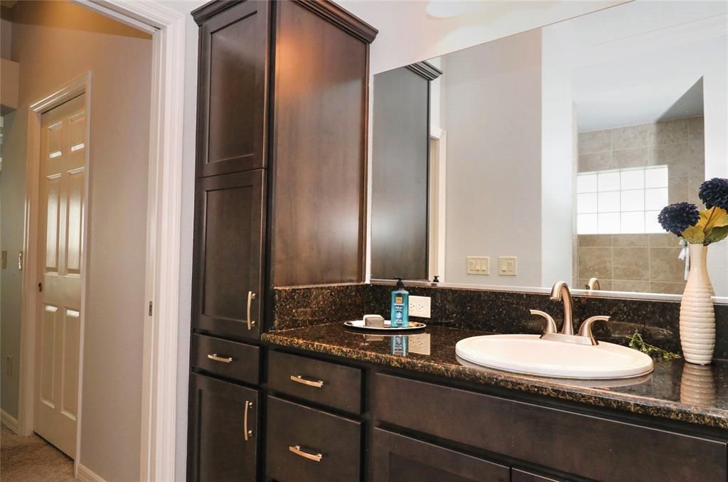 Dual sinks and a linen closet in the Master bathroom