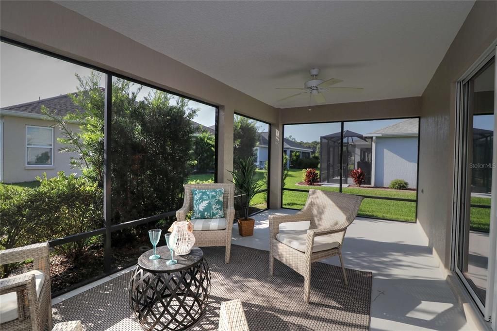 Lovely extended lanai has plenty of room for furniture or a table and chairs.