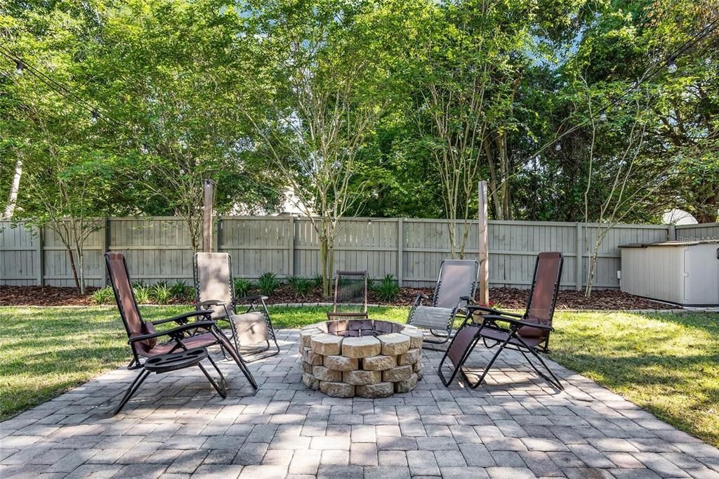 Fenced rear yard and patio with fire pit
