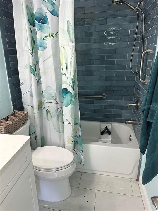 Newly updated coastal bathroom with full sized tub and shower