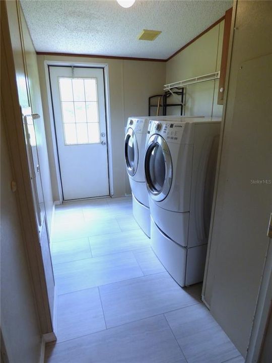 Laundry room with door to enter back yard