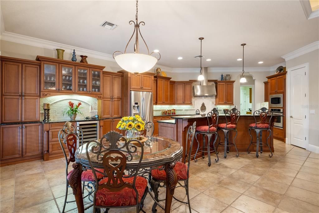 Amazing Kitchen has enormous storage space and love Bar area with tumbled stone back splash