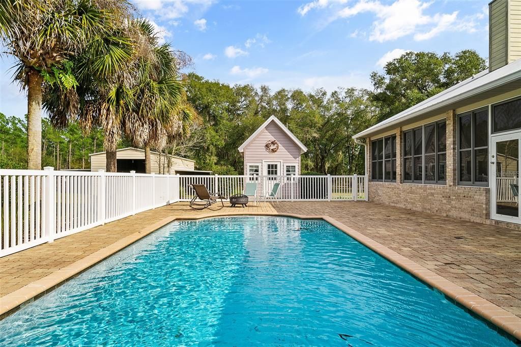 Saltwater pool, cabana, and back of sunroom