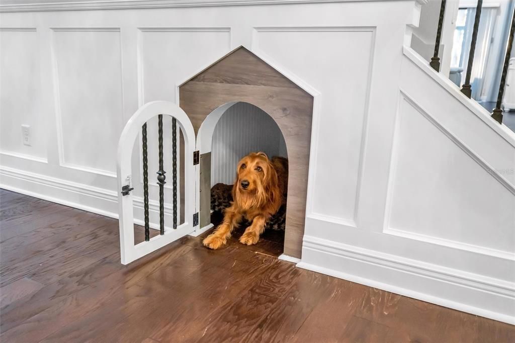 Custom doghouse under the stairs.