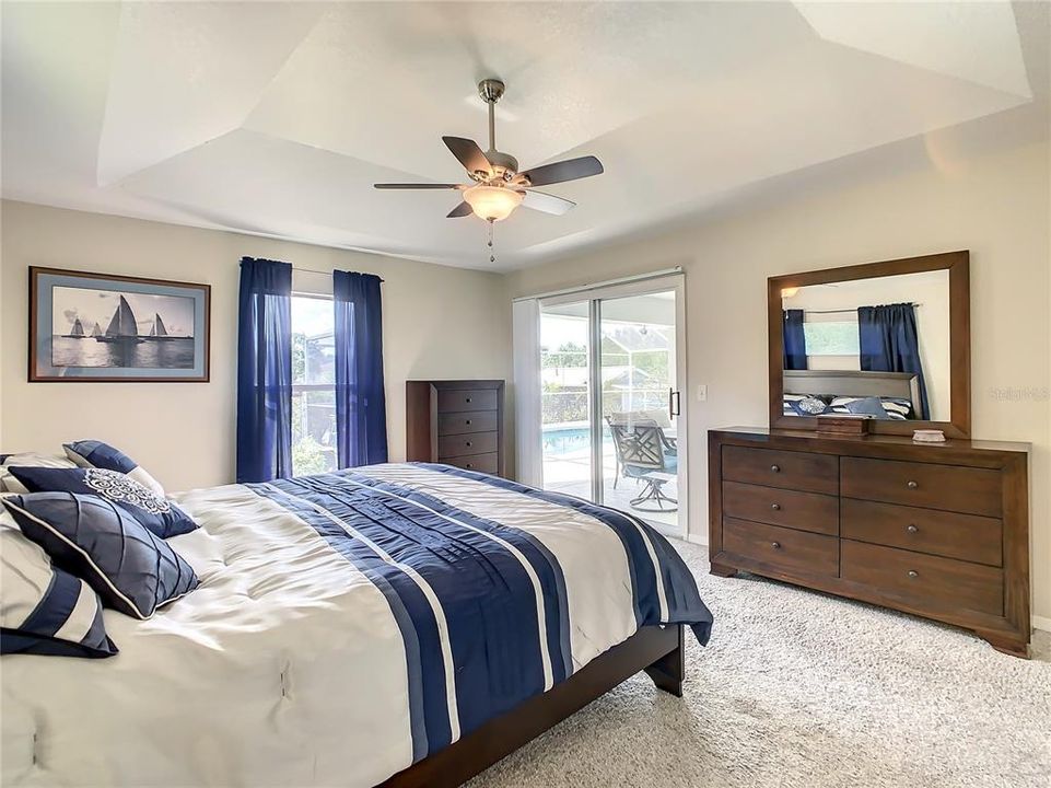 Master Bedroom has sliding glass doors that lead to the covered and screened lanai.