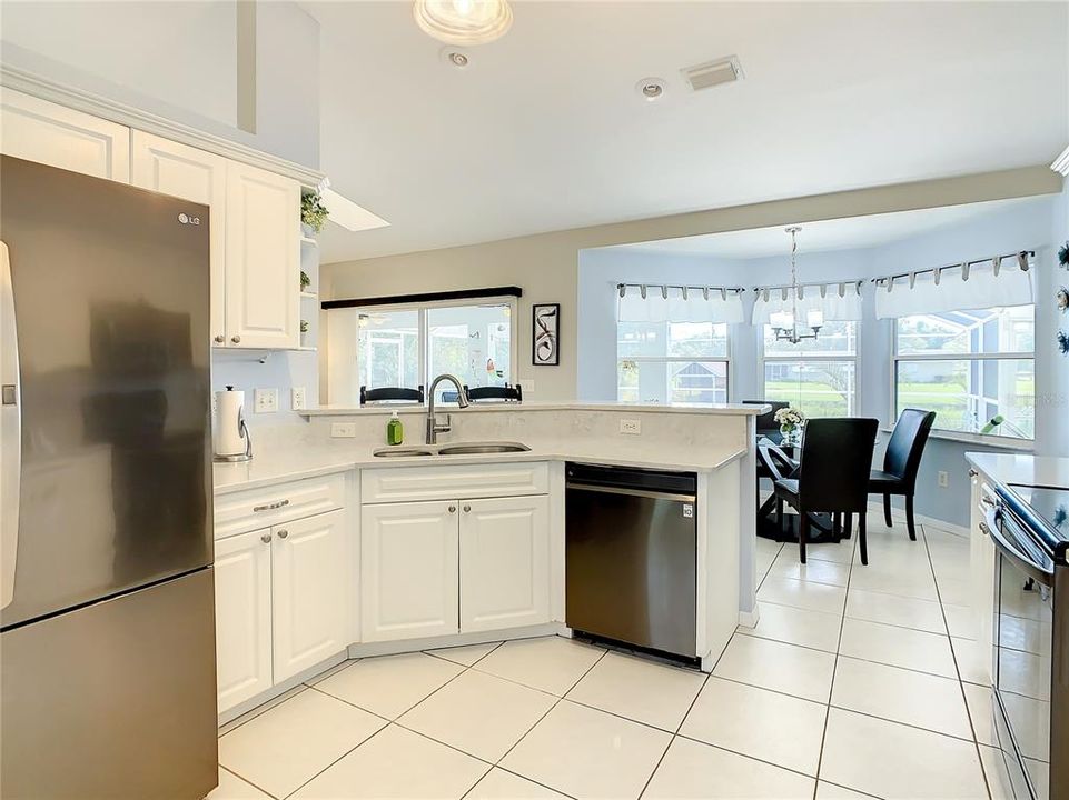 Kitchen has slate stainless steel appliances and quartz counter top and backsplash.