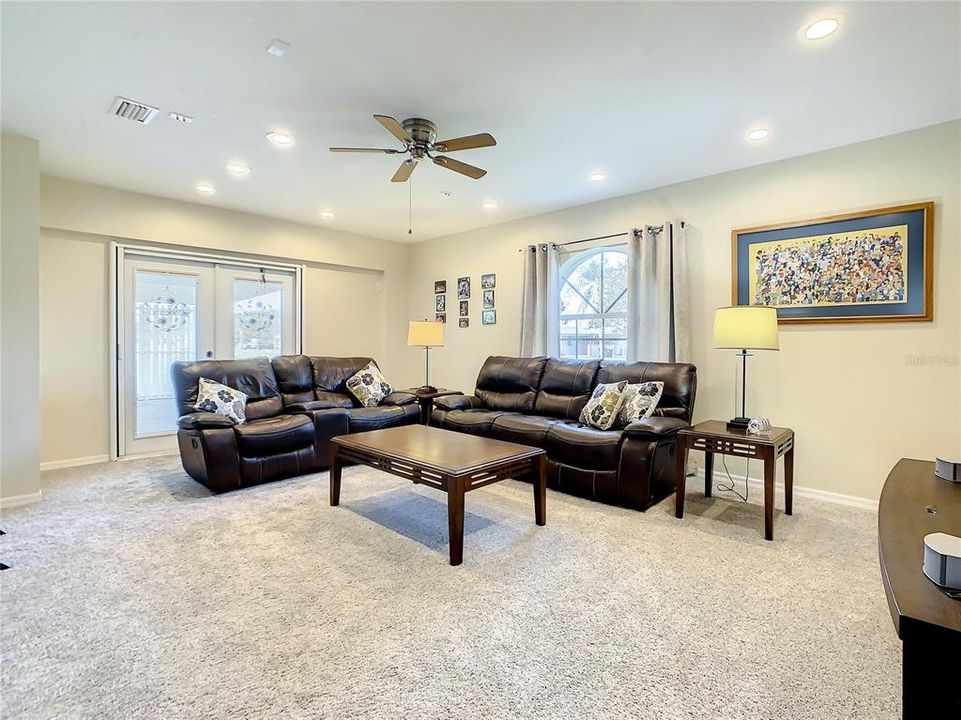 Large family room could easily be converted to a theater room.  French Doors at the back of the picture lead to the side yard and carport area.