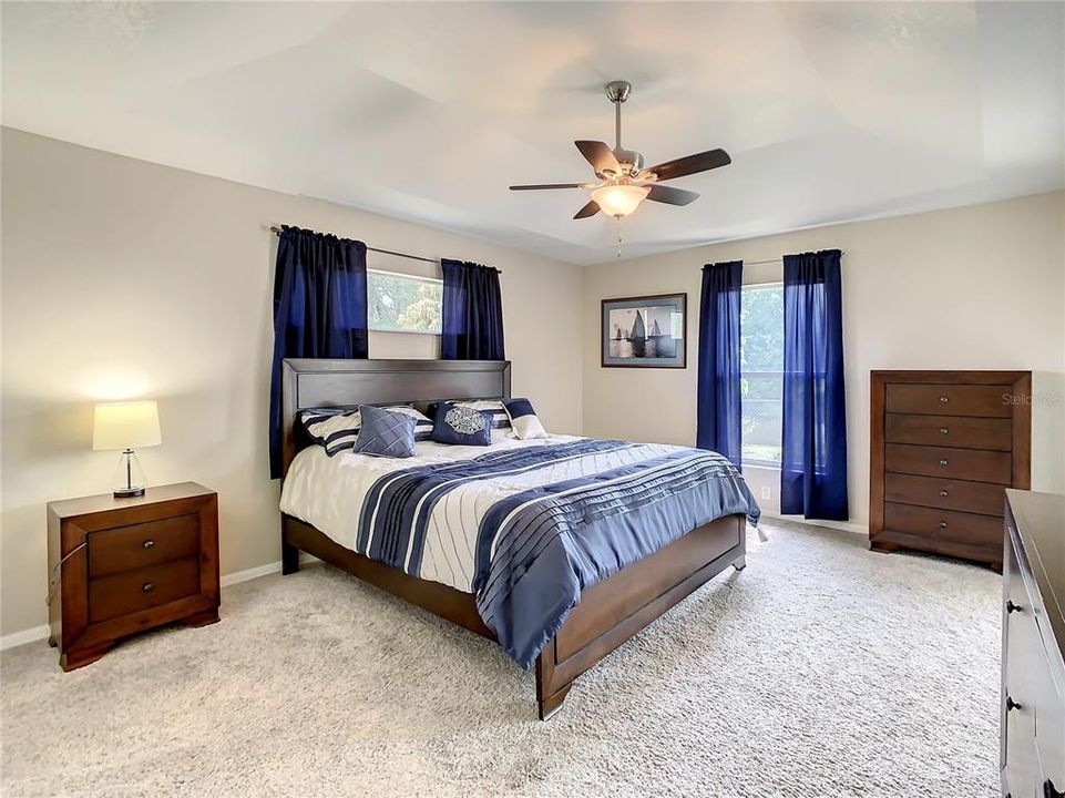 Transom window over the bed adds additional natural light.  New ceiling fan with LED lighting.