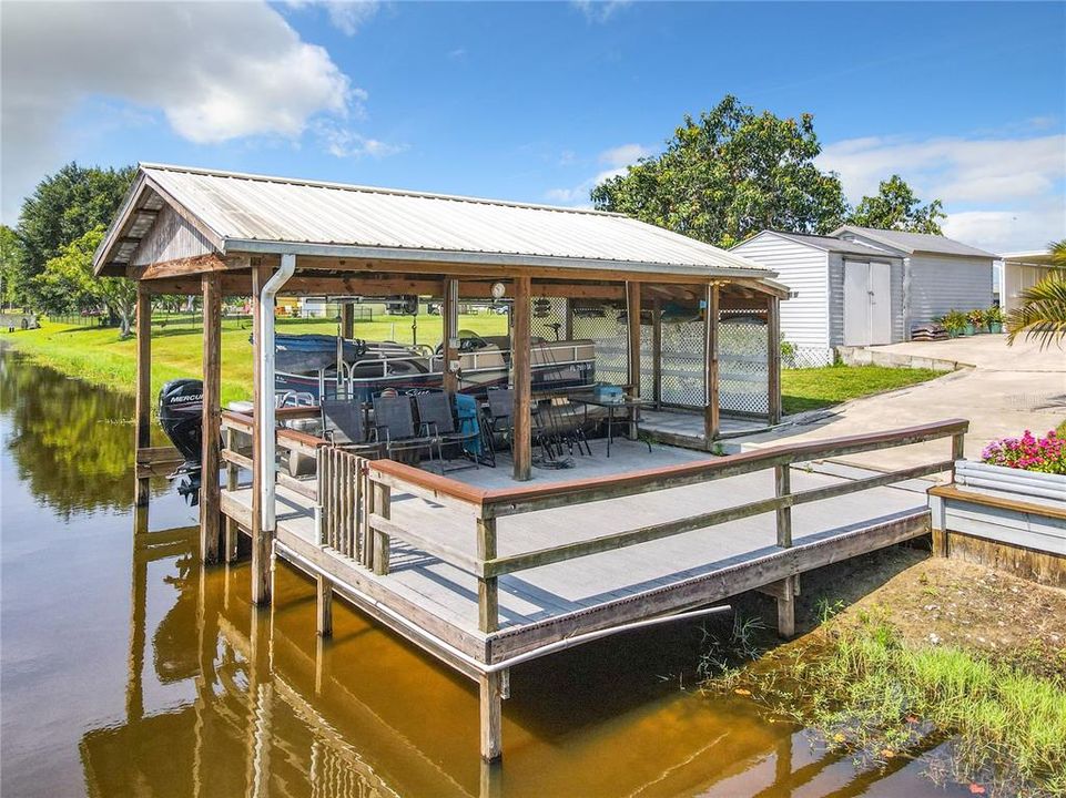 Boat house with lift, electric and water and nice sitting area.