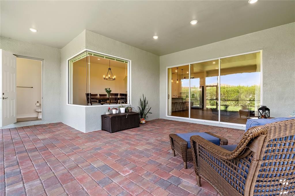Gorgeous covered enclosed lanai area with 1/2 outdoor bathroom