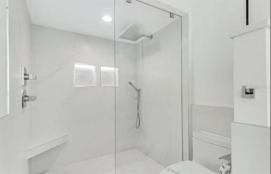 Gorgeous glassed-in standing shower with rain head shower