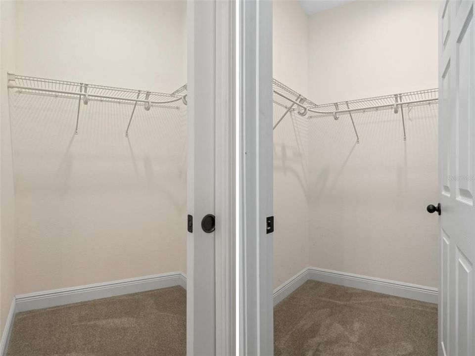 Two walk-in primary suite closets. One is located at each end of the primary bath.