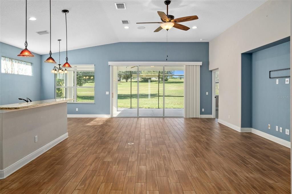 The heart of the home: the great room and kitchen with ceramic wood-like plank tile, accent lighting, and accent walls makes for a nice home. Plus, great golf course views from anywhere in the room!