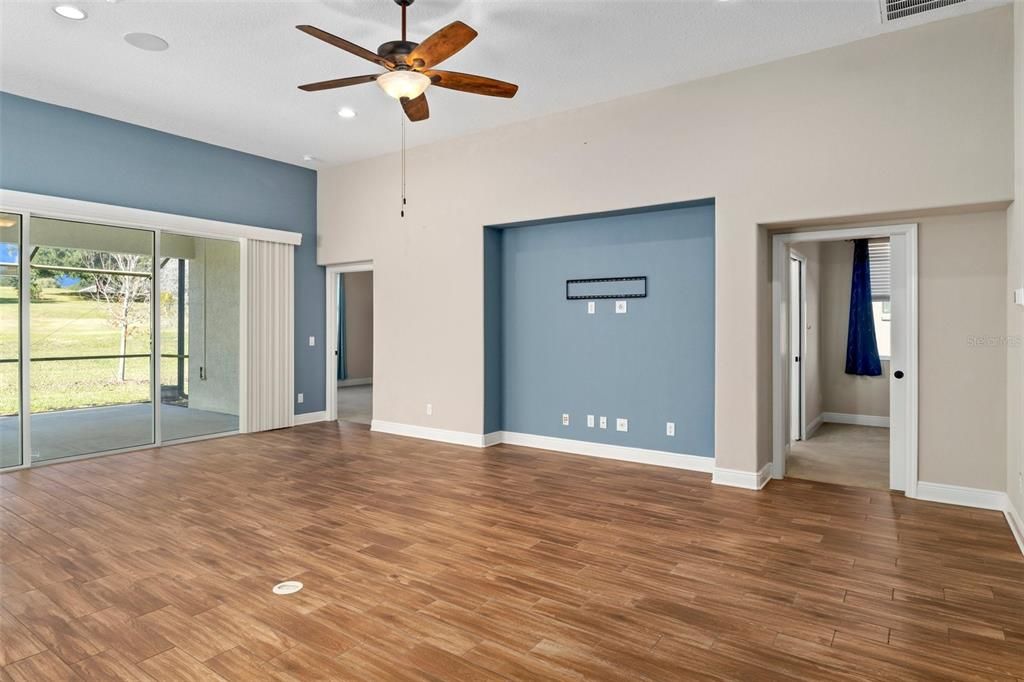 Image without furniture. White plate in the floor is an outlet - great to plug in lamps or electric reclining furniture. This room also has surround speakers in the ceiling.