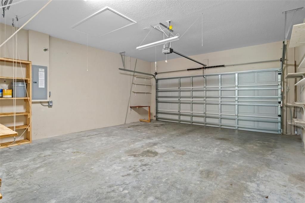 Oversized garage with room for a workbench.