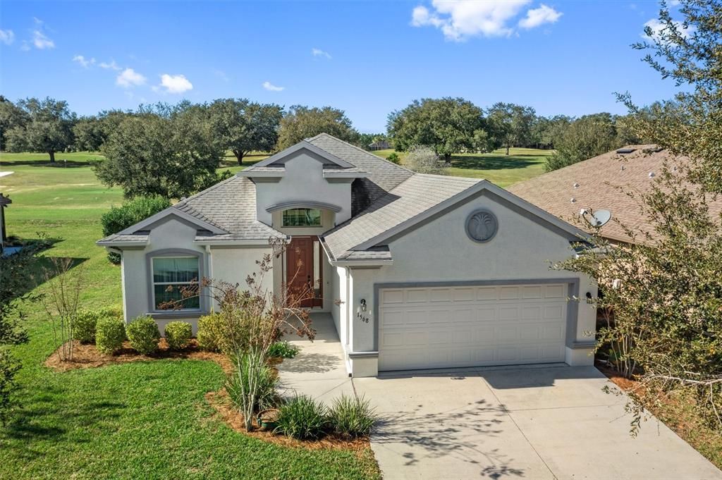 Welcoming curb appeal, with the easement to the left which provides more space between house to the left. Notice the extra wide driveway which extends beyond the width of the garage door opening.