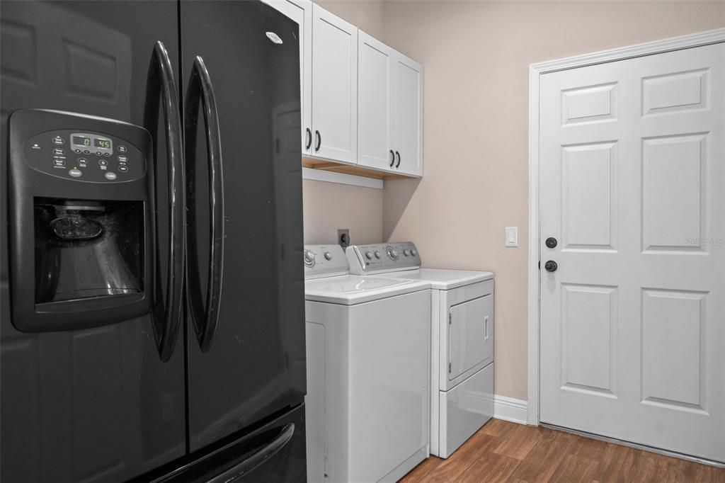 The oversized laundry room with full size secondary refrigerator (which stays with house!).