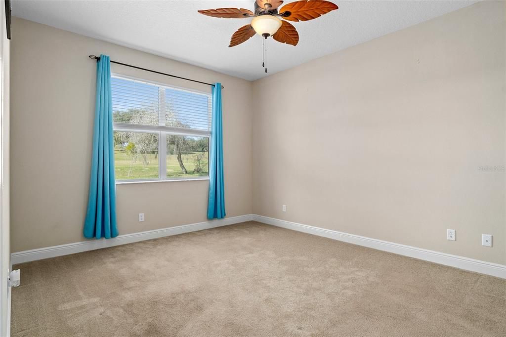 The first primary bedroom is in the rear of the home with views of the golf course. Ample room for a king bed and furniture.
