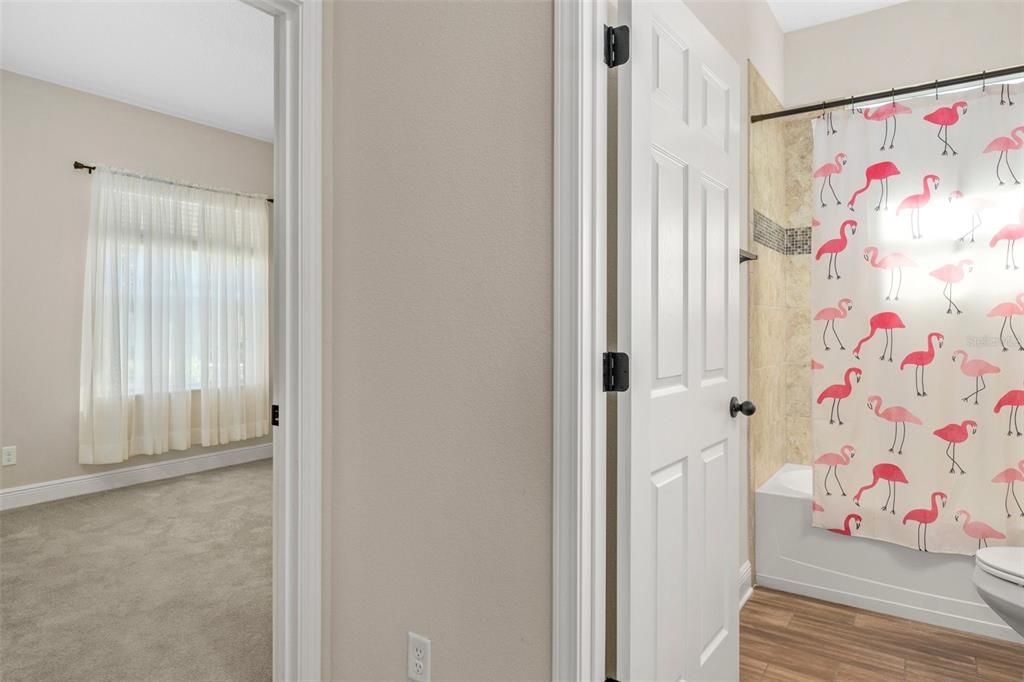 The guest bedroom is toward the left and situated in the front of the home. The guest bath is right off the entry hall. Out of the picture is a linen closet to the right. Turn this into a private guest suite by closing the pocket door off of the entry hall.