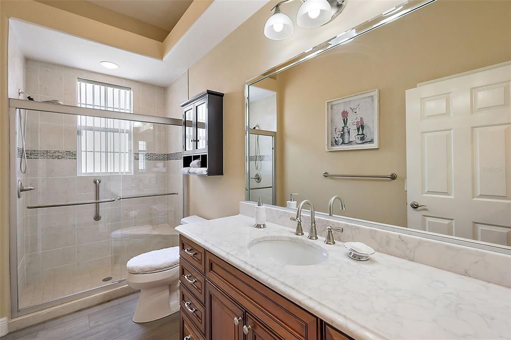 Guest bathroom w/quartz countertop & tiled walk in shower