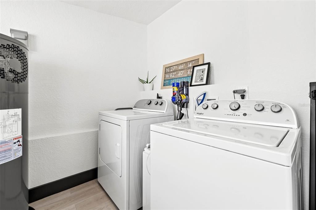 Large indoor laundry area with room to hang clothes, store all of your cleaning supplies and more!