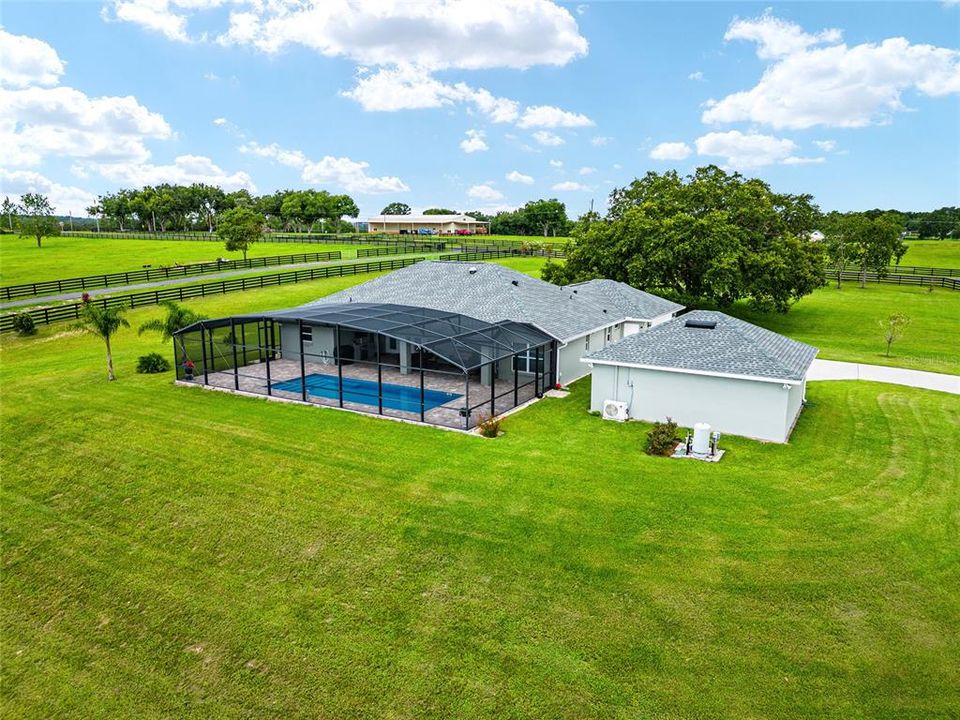 AERIAL VIEW of back exterior features pool enclosure & back of detached 2 CAR GARAGE