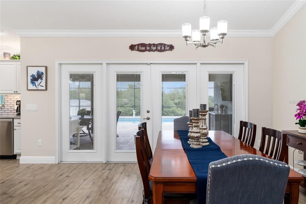 FRENCH DOORS lead out to covered LANAI & POOL areas