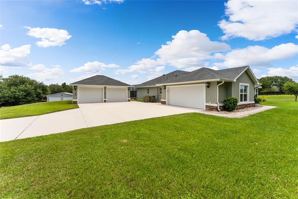 SIDE EXTERIOR view shows CONCRETE DRIVEWAY to the ATTACHED & DETACHED GARAGES for a total of 4 car spaces!