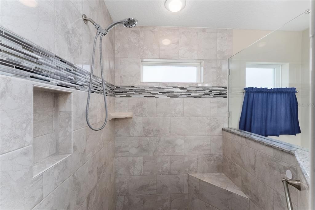 PRIMARY/MASTER BATHROOM - ROMAN SHOWER has raindrop shower head, hand held shower head, & built in seat.