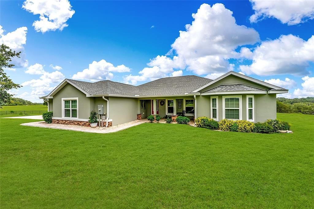 FRONT EXTERIOR - 41564 Haywood Grove Rd, Weirsdale, FL - CBS Custom home w/ 3 BR/3 BA/4 CAR GARAGE spaces nestled on 4.75 Acres parcel