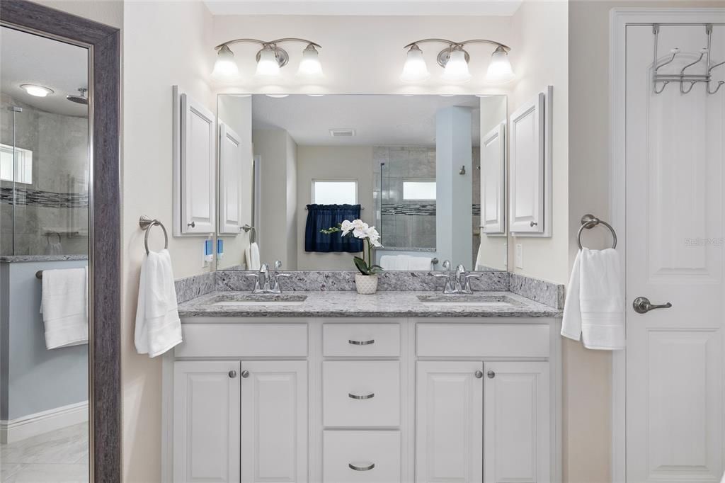 Close up view of full length mirror (L) DUAL SINKS/VANITY, GRANITE COUNTERTOP (Center), & LINEN CLOSET (R)