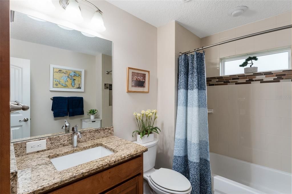 BATHROOM #2 has TUB/SHOWER COMBO, TILE SURROUND, COMFORT HEIGHT TOILET, single sink/vanity w/ GRANITE COUNTER & BUILT IN LINEN CLOSET