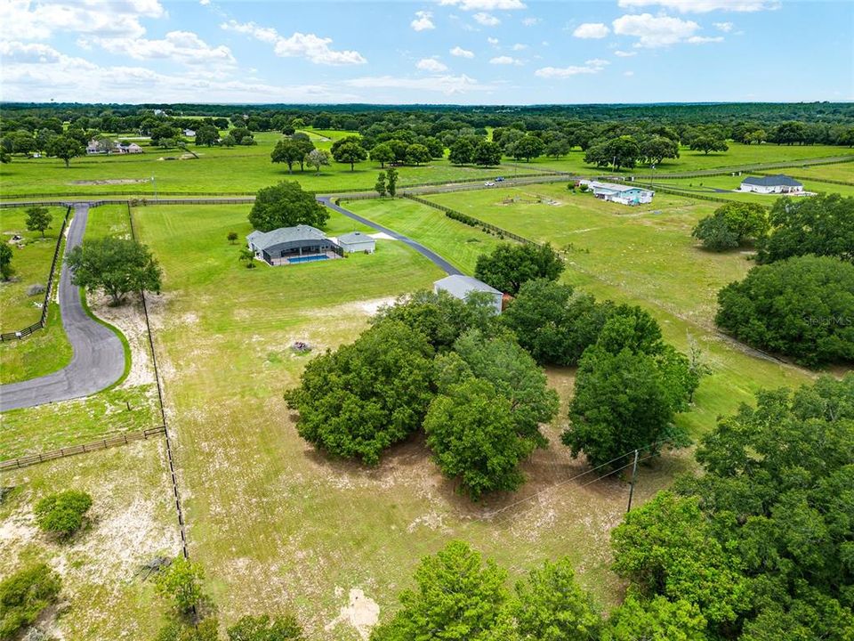 AERIAL VIEW shows back boundary with power line in easement