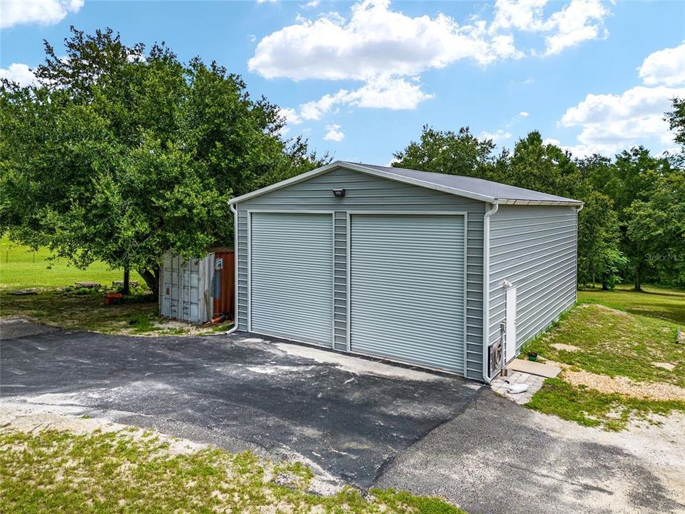 STORAGE BLDG 40' L x 30' W x 15' H (R) + SHIPPING CONTAINER for extra storage (L)