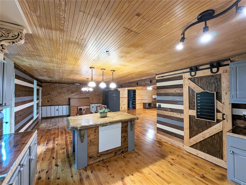 Island overlooking dining room, barn door pantry to the right.