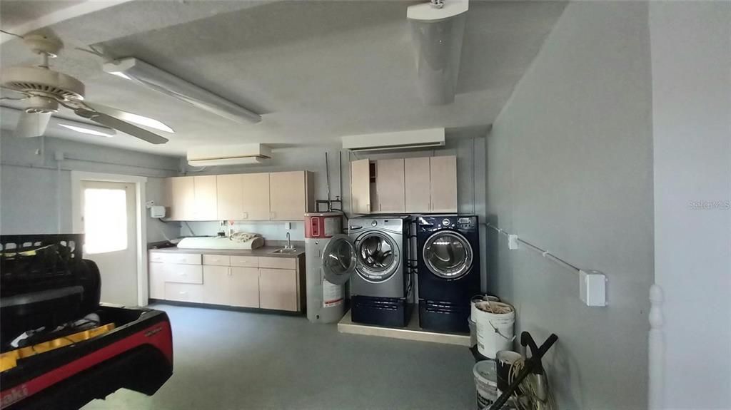 Clean 2 car garage with washer dryer and workshop