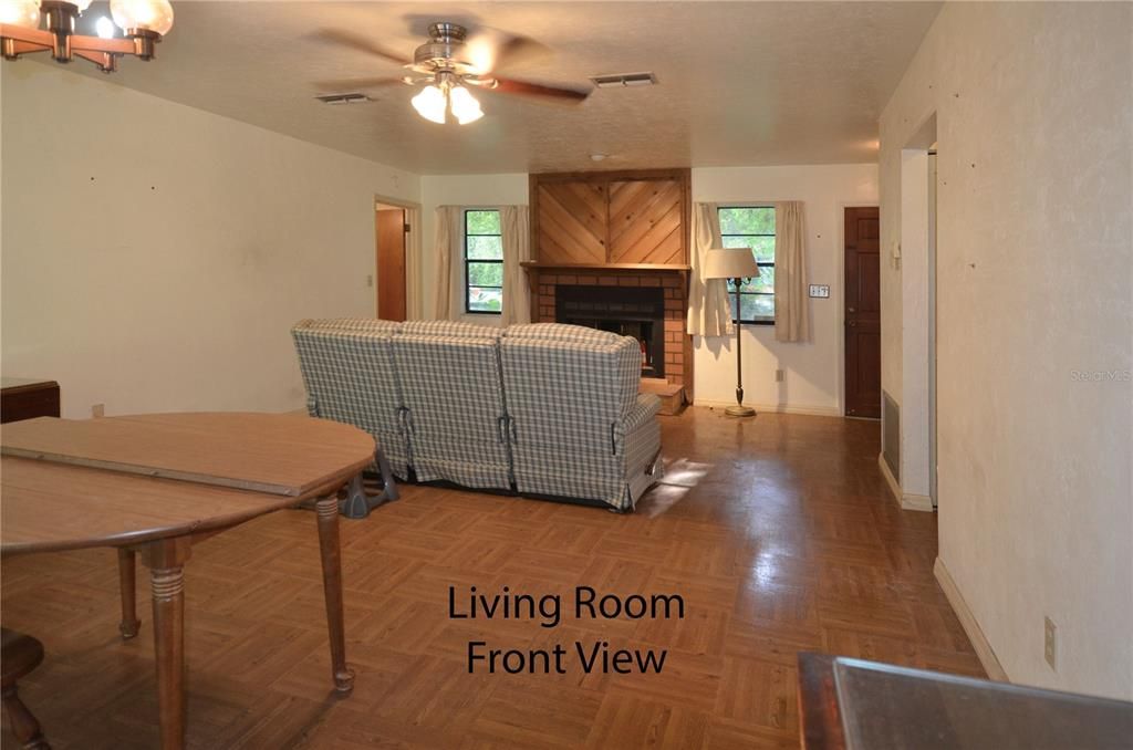 open concept living/dining room with fireplace