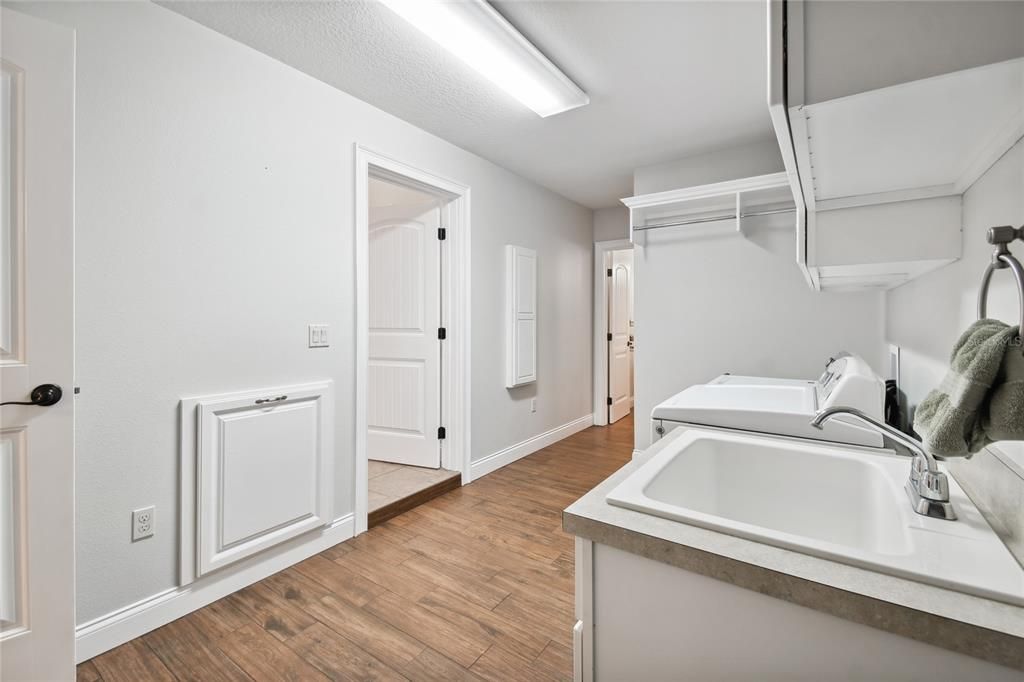 Laundry room with chute from primary bedroom