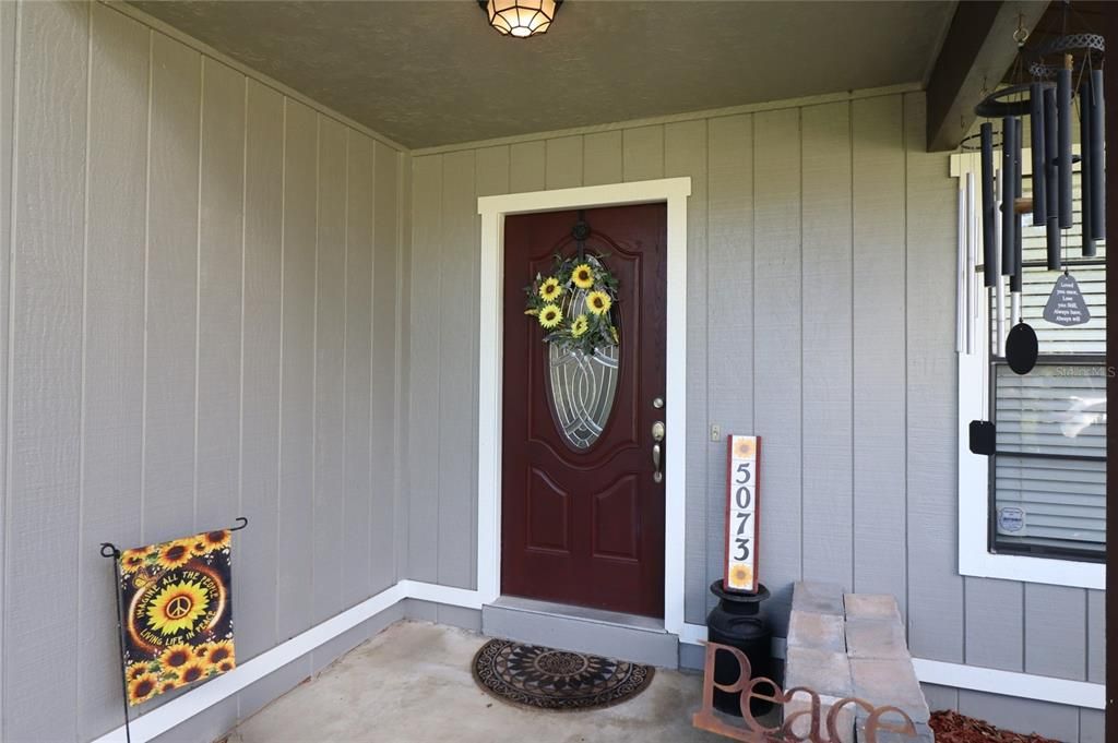 Covered entry & glass insert door welcome you.....