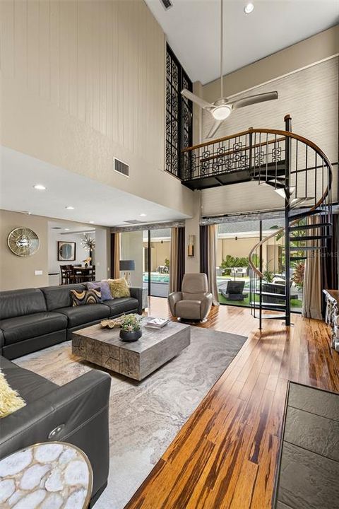 LIVING ROOM WITH SPIRAL STAIRCASE TO UPSTAIRS