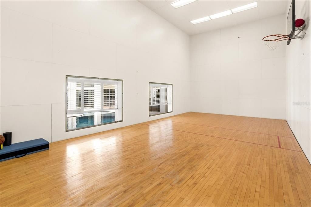 Racquetball court has a basketball hoop and acrylic windows for all sports