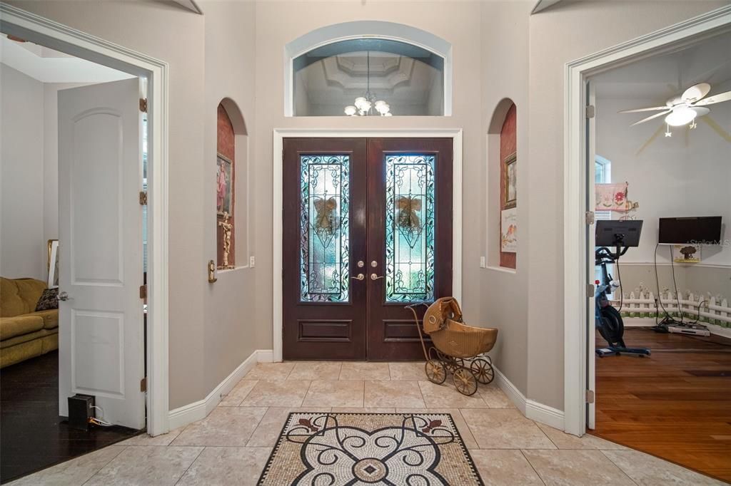 Custom foyer with tray ceilings and mosaic tile work