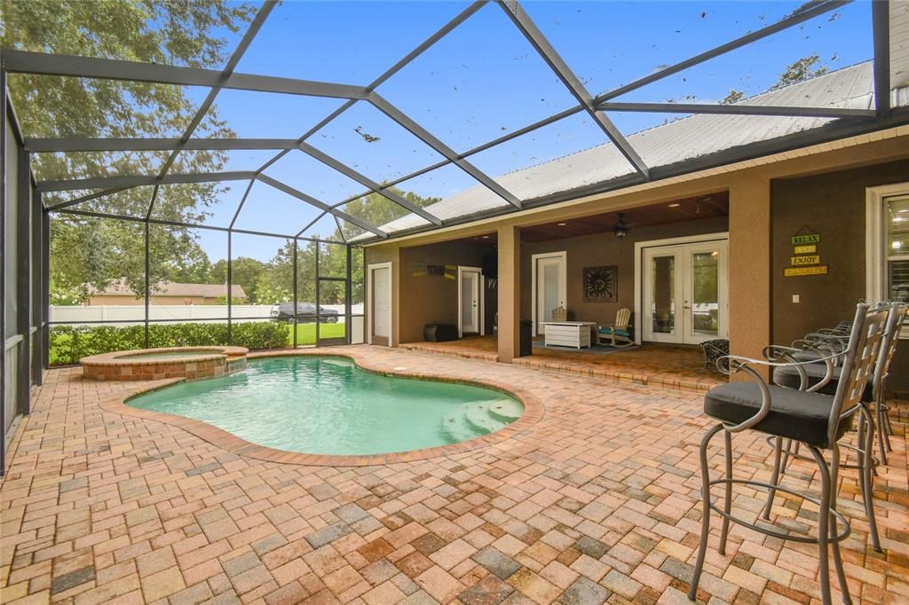 Pool area with Pavers, includes 1/2 bath with outside door.