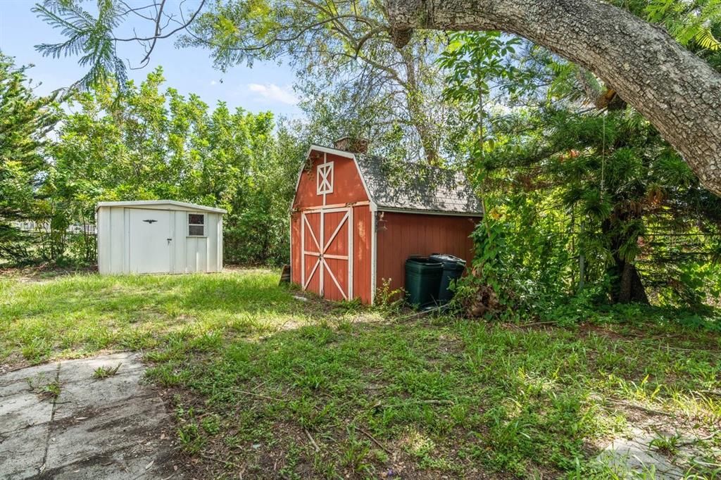Cute fenced yard with 3 sheds that will convey
