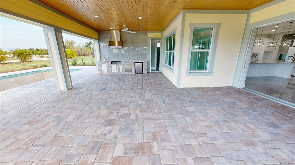 Covered lanai, screened pool enclosure and grilling kitchen