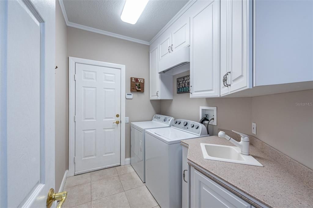 Laundry room has extra storage cabinets, sink and counter space for folding. Washer & dryer are included. Note: Washer and dryer are included.