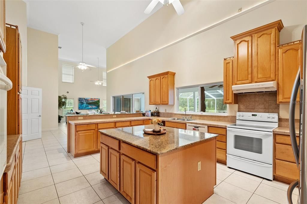 The kitchen area is designed with an open concept, allowing for a seamless view of the pool area through large sliding glass doors.